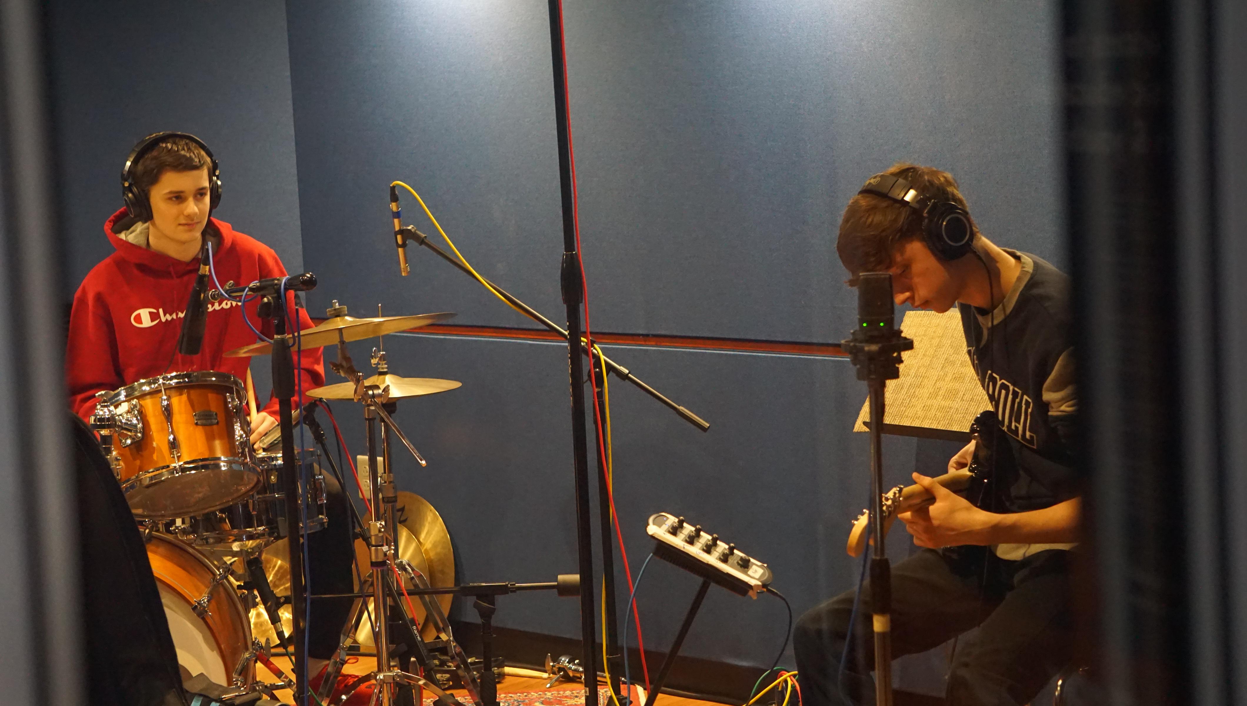 students playing musical instruments in recording studio