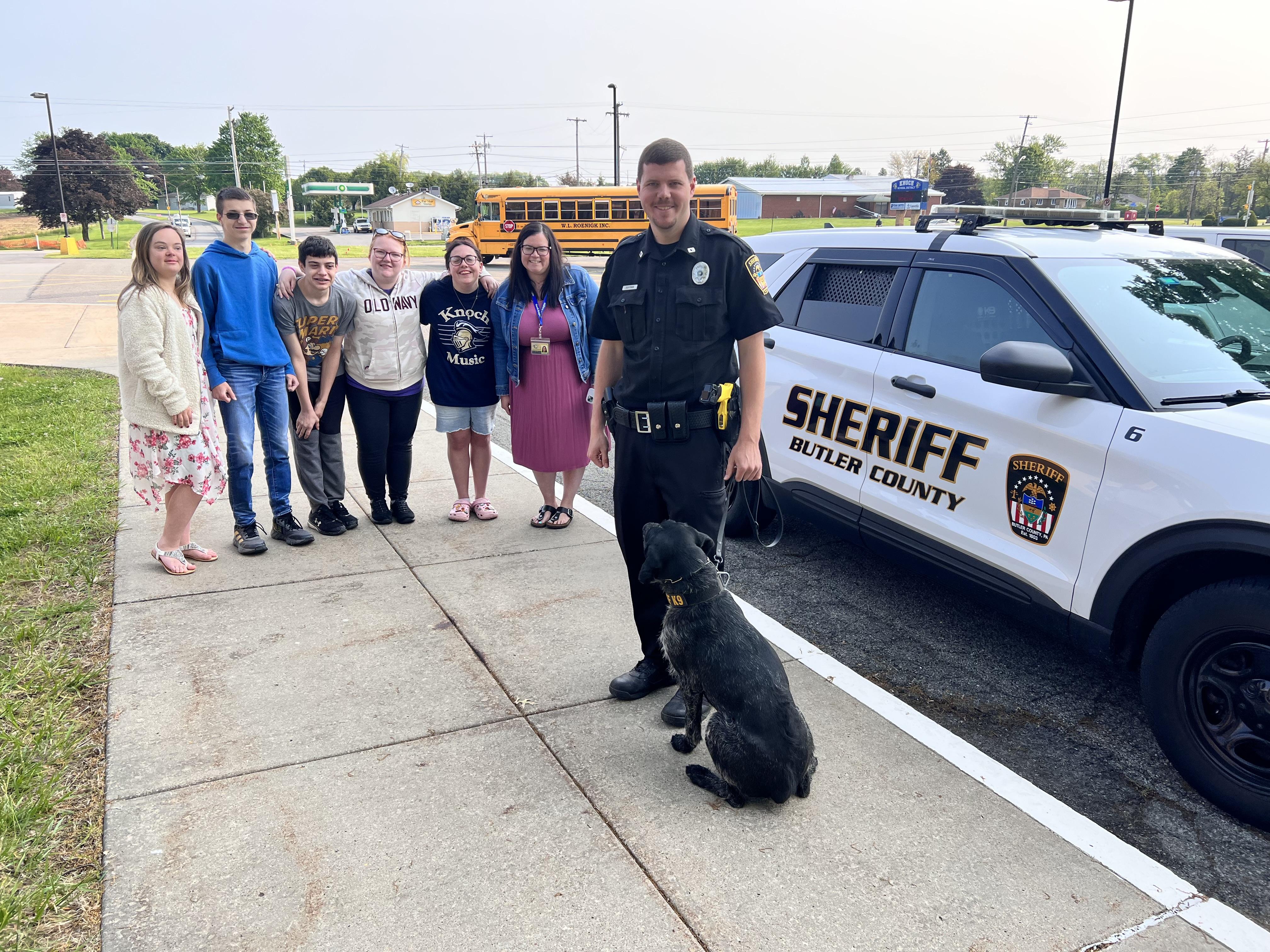 pic of an officer and a K9 with students